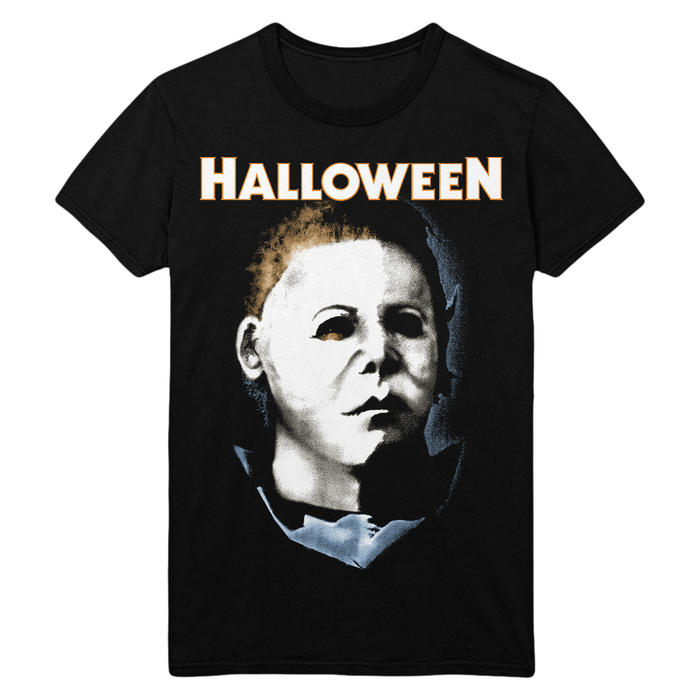 A black short-sleeve crewneck t-shirt featuring a graphic print of Michael Myers from the movie Halloween, with the word 'HALLOWEEN' printed in white and orange above the portrait.