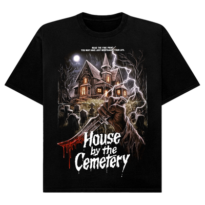 Black t-shirt with a graphic design of a house by a cemetery and a hand holding an knife.