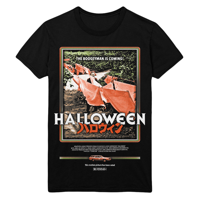 A black short-sleeve graphic T-shirt featuring a vintage-style Halloween movie poster print with the title 'HALLOWEEN' in large white letters and orange Japanese text below, shown on a plain white background.