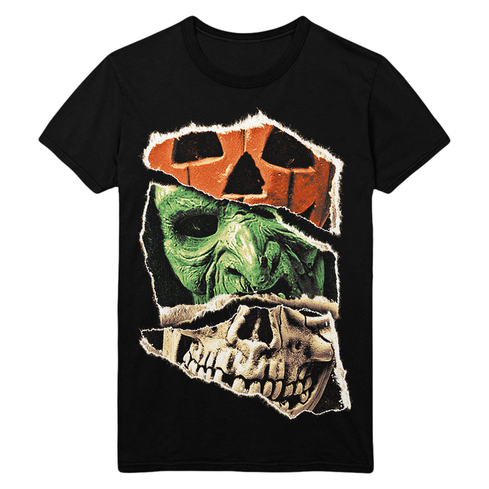 A black short-sleeve crewneck t-shirt featuring a graphic print of a zombie face tearing through a torn-paper effect that reveals an orange pumpkin head and a white skull.